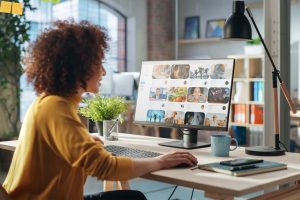 woman looking at computer screen with various images