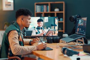 man focusing working on a video on laptop