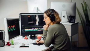 a woman staring at an rgb color wheel, working on an artistic project