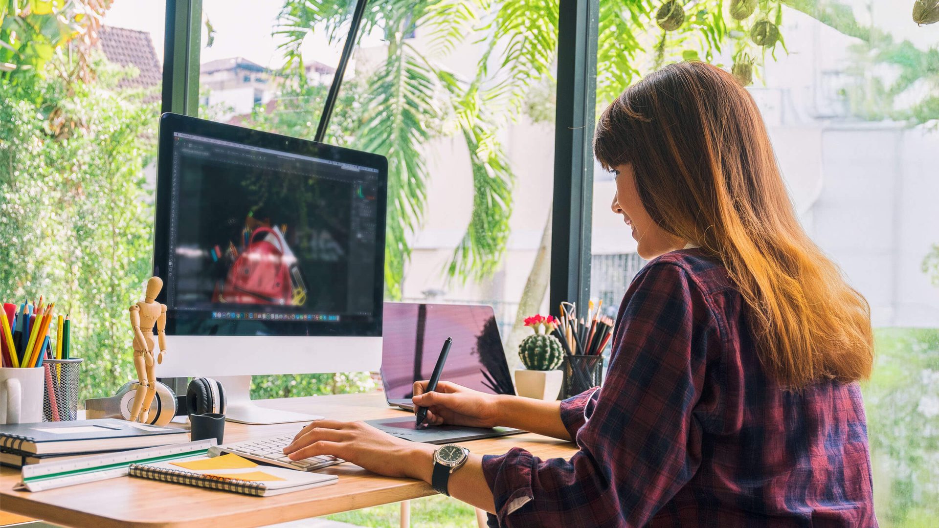 a woman creating a graphic on a computer