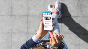a woman holding a phone looking at social media