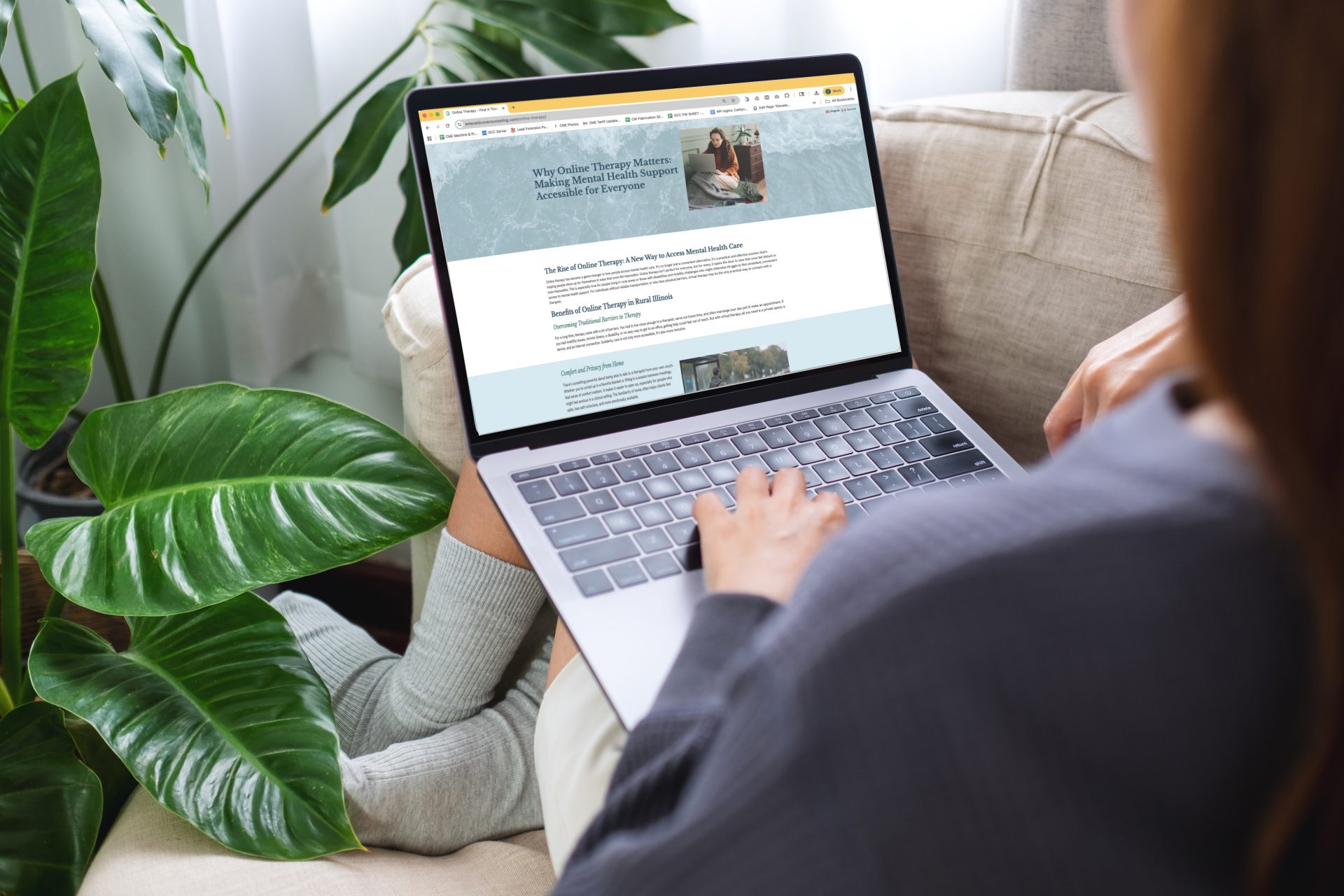 woman on a couch reading a blog post written by GCC as one of our content creation services