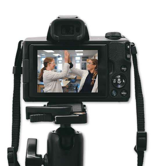 Video camera recording team collaboration scene during professional video production shoot